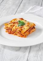 porzione di lasagne sul piatto bianco foto