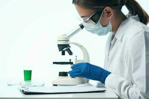 donna scienziato guardare attraverso un' microscopio ricerca biologia diagnostica foto