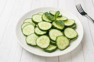 affettato cetriolo con menta su un' piatto. concetto dieta. foto