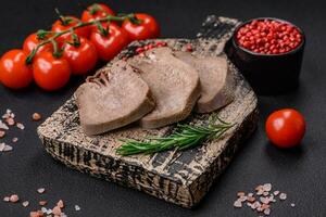 delizioso bollito Manzo lingua affettato con verdure e spezie foto