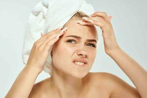 donna con asciugamano su testa acne dermatologia insoddisfazione pelle i problemi foto