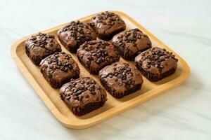 Brownies al cioccolato fondente ricoperti da gocce di cioccolato foto