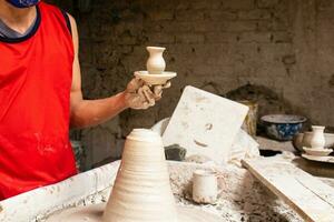 uomo fabbricazione ceramica articoli su il vasai ruota nel un' tradizionale fabbrica nel il città di raquira collocato nel il Dipartimento di cundinamarca nel Colombia foto