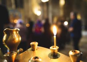 primo piano delle candele in una chiesa foto