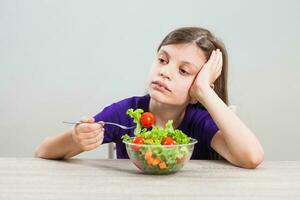 un' ragazza mangiare un' insalata foto