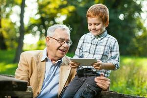 un' nonno e il suo nipote giocando scacchi foto