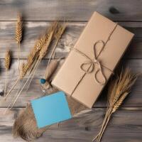 superiore Visualizza di rustico stile confezionato regalo scatola legato con tela ruvida filo, blu carta appiccicoso e d'oro secco grano erba su di legno tavolo, generativo ai. foto