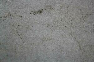 Cracked calcestruzzo parete superficie, solido suolo parete sfondo, cemento fondale foto