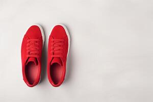 paio di nuovo elegante bianca scarpe da ginnastica su rosso sfondo. internazionale rosso scarpe da ginnastica giorno. generativo ai foto