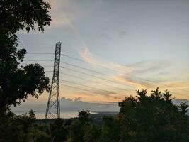 bellissimo cielo quando sole salire e tramonto con albero e Torre silhouette. il foto è adatto per uso per cielo sfondo e Alba manifesto.