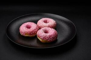 delizioso fresco dolce ciambelle nel rosa Smalto con fragola Riempimento foto