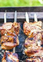 cucinando un' barbecue su il fuoco. tradizionale caucasico kebab su un' spiedo, cucinando carne su spiedini. foto