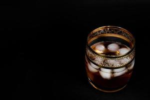 bicchiere di acquavite di whisky rosso scuro o bourbon foto
