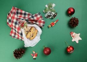 Natale natale decorazione ornamento campana regalo avvolgere affettato Stollen frutta torta cibo pino frutta su verde sfondo foto