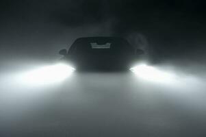 moderno guidato auto fari nel denso nebbia foto