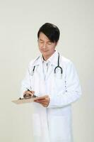 giovane asiatico maschio medico indossare grembiule uniforme tunica grembiule hold foto