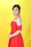 asiatico donna moderno rosso vestito su giallo rosso multicolore carta sfondo foto
