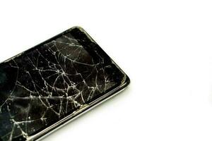 avvicinamento e Ritaglia rotto e Tirare giù di nero mobile Telefono isolato su bianca sfondo. foto