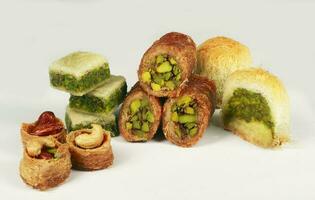 Turco, Arabo dolci, misti baklava dolci, con pistacchio e noccioline isolato su un' bianca sfondo foto