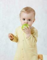 bambino è mangiare un verde Mela foto