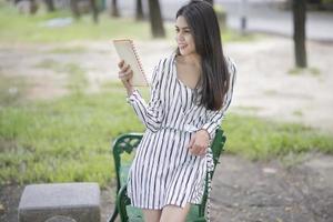 donna attraente che legge un libro nel parco
