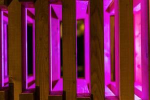 astratto sfondo di di legno stecche illuminato con viola neon leggero foto
