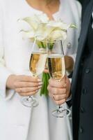 il sposa e sposo siamo Tenere Due Champagne bicchieri per il nozze cerimonia foto