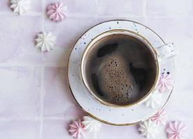 tazzina con caffè e piccole meringhe