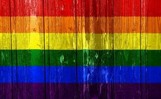 bandiera di il lgbt Comunità su il sfondo di il di legno struttura di il tavole. arcobaleno gay cultura simbolo. concetto collage. foto