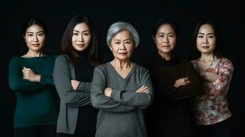gruppo di maturo asiatico donne in piedi con braccia attraversato isolato su nero sfondo. generativo ai. foto