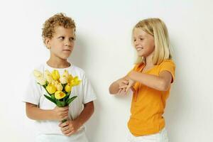 ragazzo e ragazza con un' mazzo di fiori regalo compleanno vacanza infanzia leggero sfondo foto