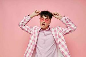 ritratto di un' giovane uomo rosa bicchieri scacchi giacca moda in posa modello studio foto