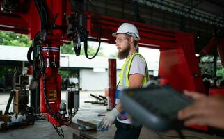 un ingegneri installazione e analisi un' grande robotica braccio. prima invio esso per i clienti per uso nel il industria foto