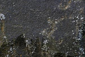 struttura in pietra nera con crepe e scheggiature, immagine di sfondo foto