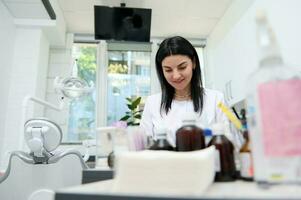 fiducioso esperto professionale dentista, femmina protesico ingegnere Lavorando con un' dentale muffa a odontoiatria clinica foto