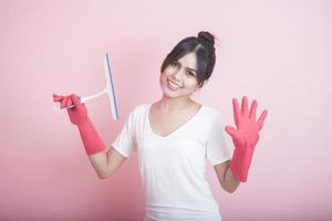 bella casalinga asiatica sorridente su sfondo rosa foto