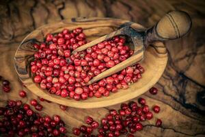 rosso Pepe a partire dal il brasiliano schinus terebinthifolia albero su oliva legna foto