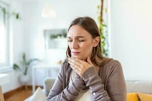 dente dolore e odontoiatria. giovane donna sofferenza a partire dal terribile forte denti dolore, toccante guancia con mano. femmina sensazione doloroso mal di denti. dentale cura e Salute concetto. foto