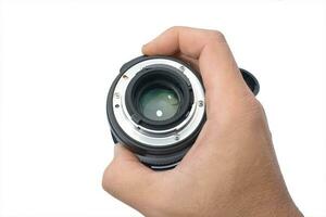telecamera lente nel maschio mano isolato bianca sfondo foto