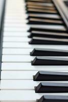 avvicinamento di pianoforte chiavi. pianoforte nero e bianca chiavi e pianoforte tastiera musicale strumento posto a il casa balcone durante soleggiato giorno. foto