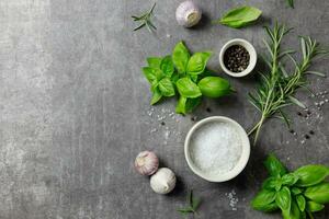 selezione di spezie erbe aromatiche e verdi. ingredienti per cucinando, cibo sfondo su buio grigio sfondo. superiore Visualizza. copia spazio. foto