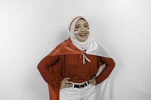 contento sorridente indonesiano musulmano donna indossare rosso superiore e bianca hijab Tenere dell'Indonesia bandiera per celebrare Indonesia indipendenza giorno. isolato di bianca sfondo. foto