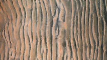 la superficie dello sfondo della spiaggia di sabbia