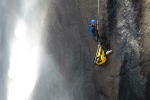 un' persona su un' corda arrampicata su un' cascata foto