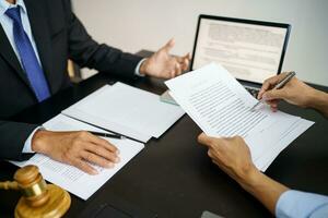 il consulente legale presenta al cliente un contratto firmato con martelletto e diritto legale. concetto di giustizia e avvocato foto