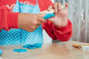 figli di mani e simulazione cucinando giocattoli nel il cucina contatore. foto