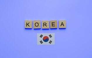 agosto 15, nazionale liberazione giorno di Corea, il bandiera di Corea, un' minimalista bandiera con il iscrizione nel di legno lettere su un' blu sfondo foto