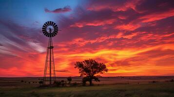 colorato tramonto con mulino a vento e alberi nel rurale Kansas nord di hutchinson. silhouette concetto foto