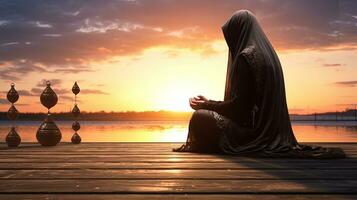 musulmano donna utilizzando perline per pregare a Alba fuori. silhouette concetto foto