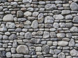 muro di pietra grigia come trama di sfondo foto